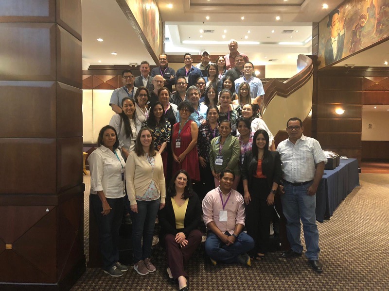 Group photo of the conference participants on hotel stairs.